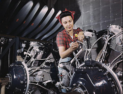 A woman working on an airplane motor